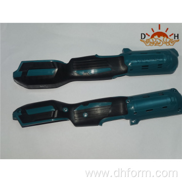 Two color plastic injection molded power tool handles
